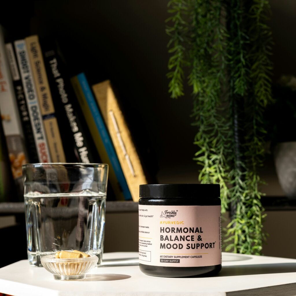 Image of glass of water and a bottle of mood and hormone balancer for menopause
