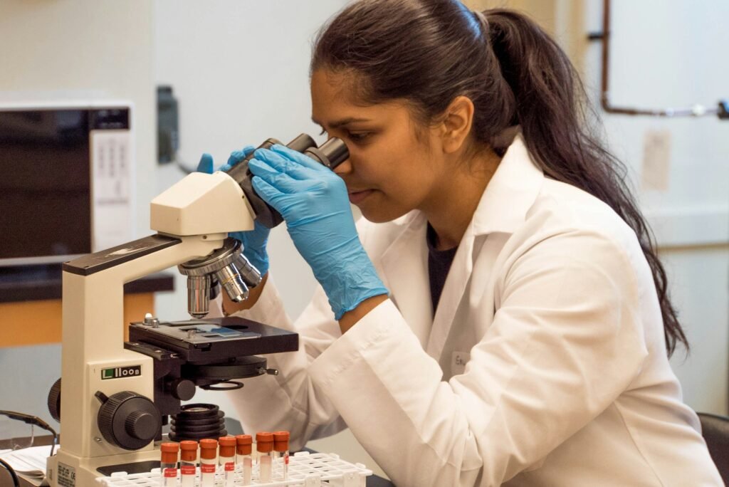 Female scientist looking into a microscope