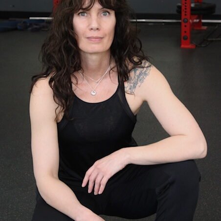 Image of me Crouching Personal trainer kneeling on the floor at Rage Fitness in Calgary Alberta